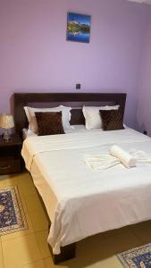 Ένα ή περισσότερα κρεβάτια σε δωμάτιο στο Appartements Meublés Elégants et Spacieux à Tradex Ahala - Yaoundé
