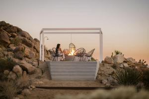 a couple sitting at a table under a tent at Bolder House By The Cohost Company in Joshua Tree