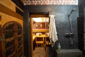 a bathroom with a shower with a table in it at Éco-domaine Gîtes et Spa - Mer, Nature & Confort - Côte d'Opale in Wierre-Effroy +18 photos