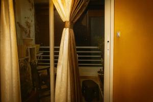 a curtain on a window in a room at VVIP Address Homestay Jagatpura Jaipur Luxury Stay in Jaipur