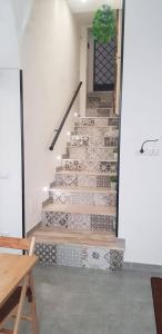 a set of stairs in a room with a door at casa di Francesco e Azzurra in Torre del Greco +6 photos