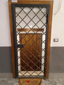 a wooden cabinet with a glass door with a wooden box at casa di Francesco e Azzurra in Torre del Greco +3 photos