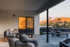 a living room with a view of the desert at Desert Bloom By The Cohost Company in Joshua Tree +82 photos
