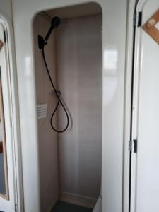a shower in a room with a shower curtain at catamaran nautilodge in Sainte-Anne