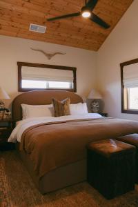 a bedroom with a large bed with a ceiling at Wild Moon Ranch Pickleball, Cedar Tub & Views in Julian