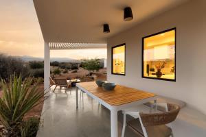 a dining room with a table and chairs and a view at Nexus By The Cohost Company in Pioneertown