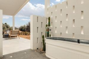 a white block wall next to a patio at Nexus By The Cohost Company in Pioneertown