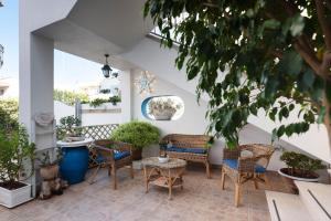 a patio with chairs and a table and some plants at B&B Antiche Stelle Salento in Salve
