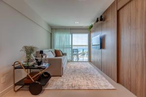 a living room with a couch and a table at Aconchegante apartamento em Cloc Marina Residence in Salvador
