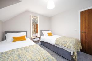 Ένα ή περισσότερα κρεβάτια σε δωμάτιο στο Glencairn by Escape Ordinary
