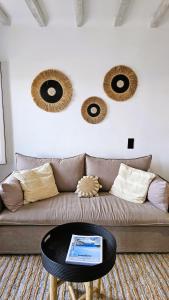 a living room with a brown couch with a table at Villa Spika with seaview and shared pool in Kalo Livadi