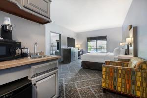 a large hotel room with a bed and a kitchen at Wyndham Garden Appleton in Appleton