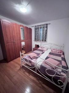 a bedroom with a bed and wooden floors at Adrialana in Porozina