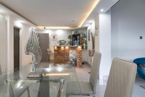 a dining room with a glass table and chairs at Achill Guest House in Solihull