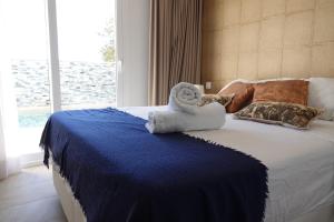 a bedroom with a bed with a towel on it at Guardamar Sea View Villa in Guardamar del Segura