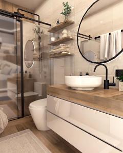 Sunset Dream Luxury Villa في كيري: حمام مزود بحوض ومِرآة