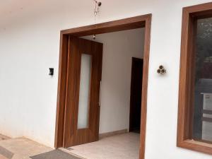 a wooden door in a white wall at The Dayal Hotels in Ayodhya
