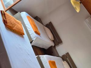 a room with two bunk beds with orange and white pillows at Fontana Traditional House in Anarita +23 photos