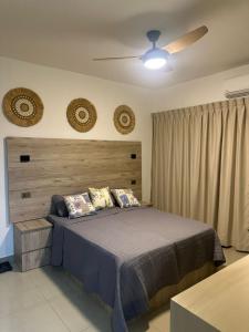 a bedroom with a bed and a ceiling fan at Sol & Arena Bayahibe Apartment in Bayahibe
