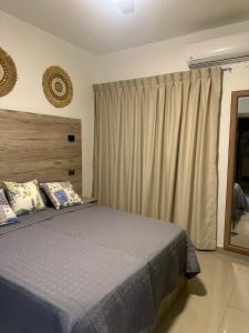 a bedroom with a bed and a large window at Sol & Arena Bayahibe Apartment in Bayahibe +29 photos