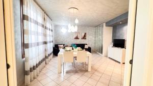 a dining room with a table and a living room at Lady Teresa 2-0 by Ca-Sa Check in Chioggia