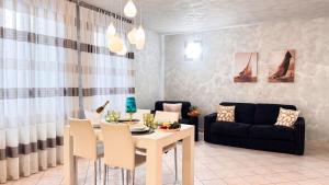 a living room with a table and a couch at Lady Teresa 2-0 by Ca-Sa Check in Chioggia +30 photos