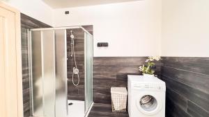 a bathroom with a washing machine and a shower at Lady Teresa 2-0 by Ca-Sa Check in Chioggia