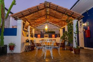 a patio with a table and chairs under awning at La Casona de Jerusalen in Arequipa