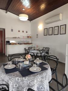 a dining room with tables and chairs in a room at Pousada Esspaço Vista Mar in Itanhaém