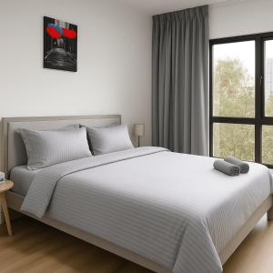 a white bedroom with a large bed and a window at Luxury 2BD with Burj Khalifa View Downtown in Dubai