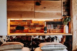 a room with a wooden wall with a shelf and a bottle of wine at StyLove-Apartamenty in Ustroń +37 photos