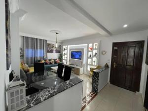 a living room with a table and a couch at Appartement cosy World Rabat in Rabat