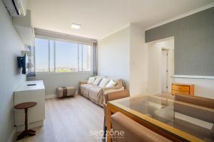 a living room with a couch and a table at Apt 2 Bedrooms w/ Air in Floripa CIS0033 in Florianópolis