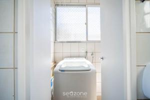 a bathroom with a toilet and a window at Apt 2 Bedrooms w/ Air in Floripa CIS0033 in Florianópolis +1 photo
