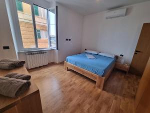 a bedroom with a bed and a large window at Queen Barbara in Genoa