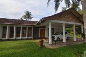 une maison avec une voiture blanche garée dans la cour dans l'établissement Matara Browns Peak, à Matara