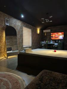 a large room with a large bed and a bar at Avrasya Inn Hotel in Baku +47 photos