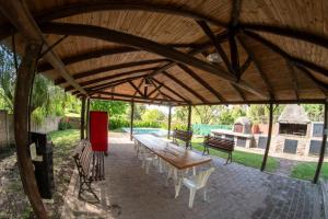 a large pavilion with a wooden table and chairs at Casa Mozart in Victoria