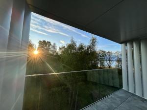 a view of the sun from the window of a house at Sea and lake apartament in Mielno