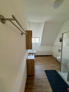 an attic bathroom with a sink and a toilet at Robbe beim Ochsenturm am Deich in Dingen +12 photos