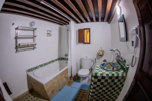 a bathroom with a tub and a toilet and a sink at Riad Dar Bahja - More Than a Stay in Fès +76 photos