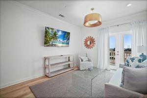 a living room with a couch and a table at Quiet Harbor Condo-Private Balcony-Relaxing Stay in Pass Christian