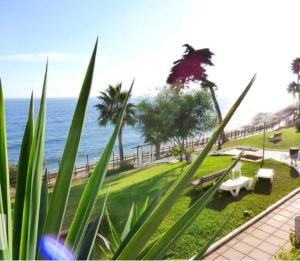 a view of a park with the ocean in the background at Apartamento Playa Algaida in Sitio de Calahonda