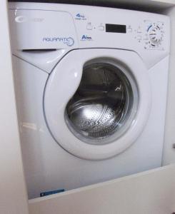 a washing machine with a silver door in a room at Studio in heart of Warsaw in Warsaw