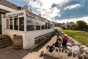 a group of people sitting outside of a train at Lochside Hotel in Bowmore +29 photos