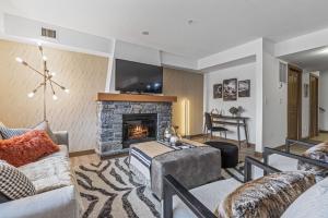 a living room with a couch and a fireplace at Free Arcade Delightful Stay in Rocky Mountains in Dead Man's Flats