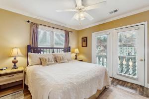 - une chambre avec un lit, un ventilateur de plafond et une fenêtre dans l'établissement The Bears Den, à Helen