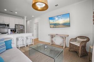 a living room with a couch and a table at Mississippi Gulf Coast Basecamp-Central Location in Pass Christian