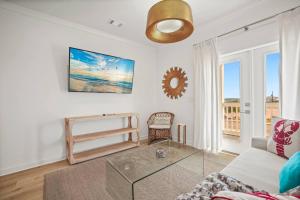 a living room with a couch and a glass table at Extended Stay Friendly-Full Kitchen & Laundry in Pass Christian