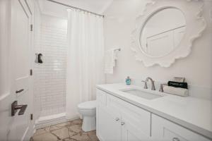 a white bathroom with a sink and a mirror at Extended Stay Friendly-Full Kitchen & Laundry in Pass Christian +31 photos